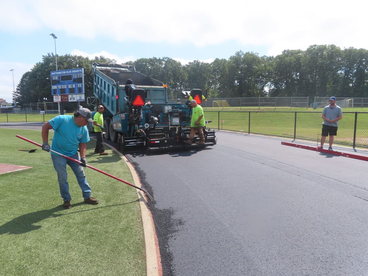 Athletic Surface Base Paving project in Southington, CT — paver laying asphalt on track