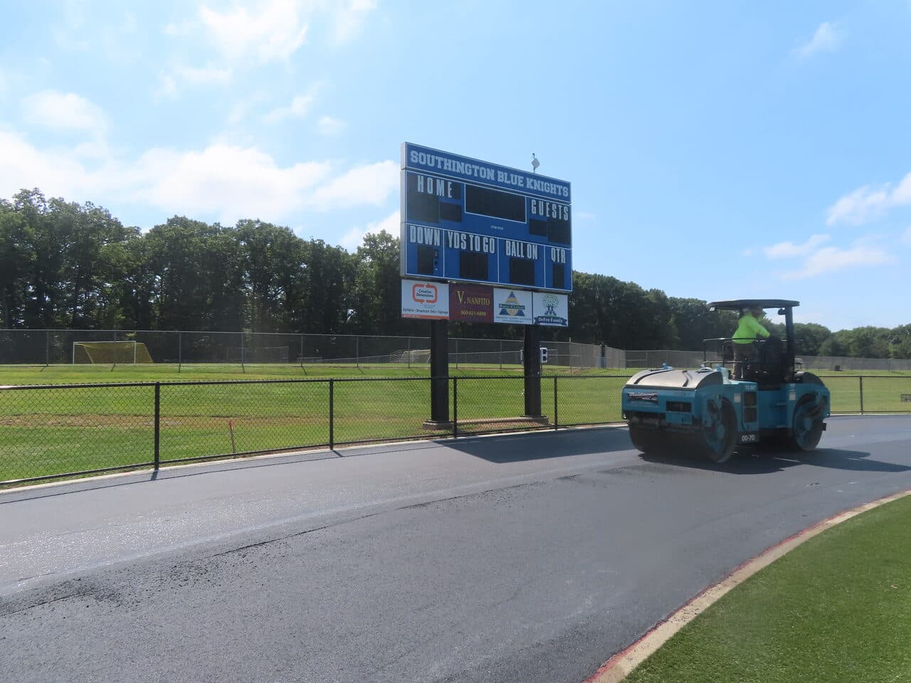 Athletic Surface Base Paving project in Southington, CT — finished asphalt track with scoreboard