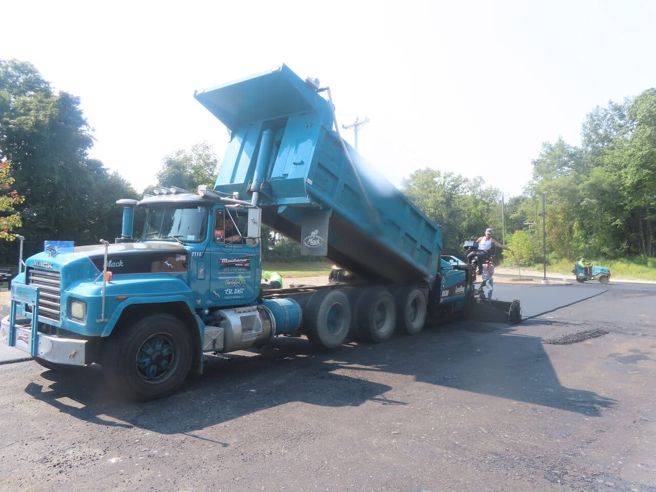 Commercial Parking Lot Paving project in Plainville, CT — blue Mack dump truck and paver