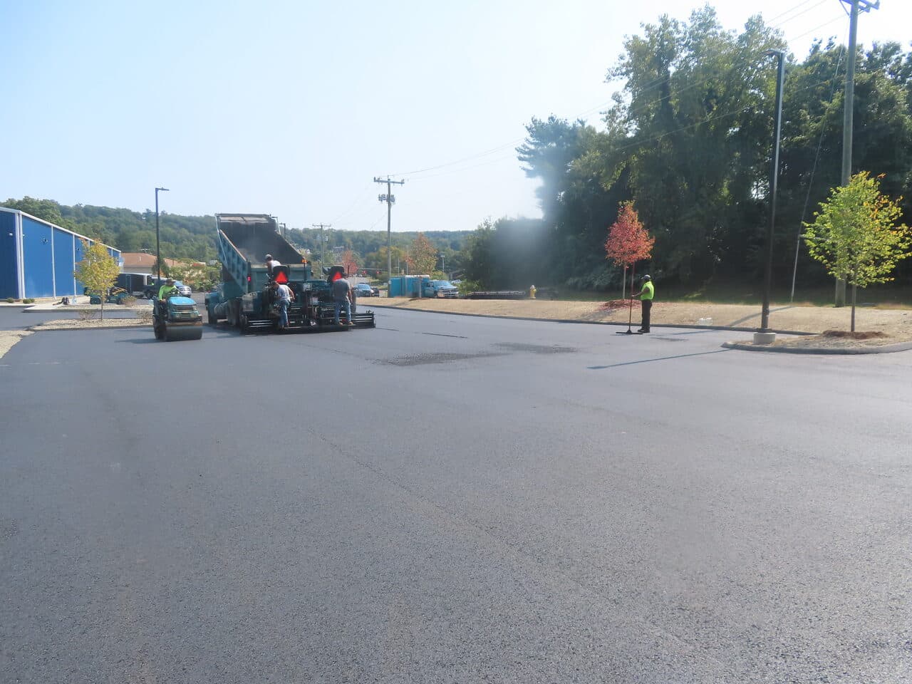 Commercial Parking Lot Paving project in Plainville, CT — paving crew with paver and roller