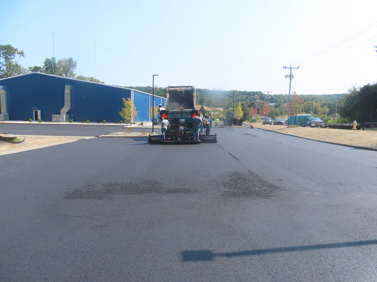 Commercial Parking Lot Paving project in Plainville, CT — paver laying mat down center