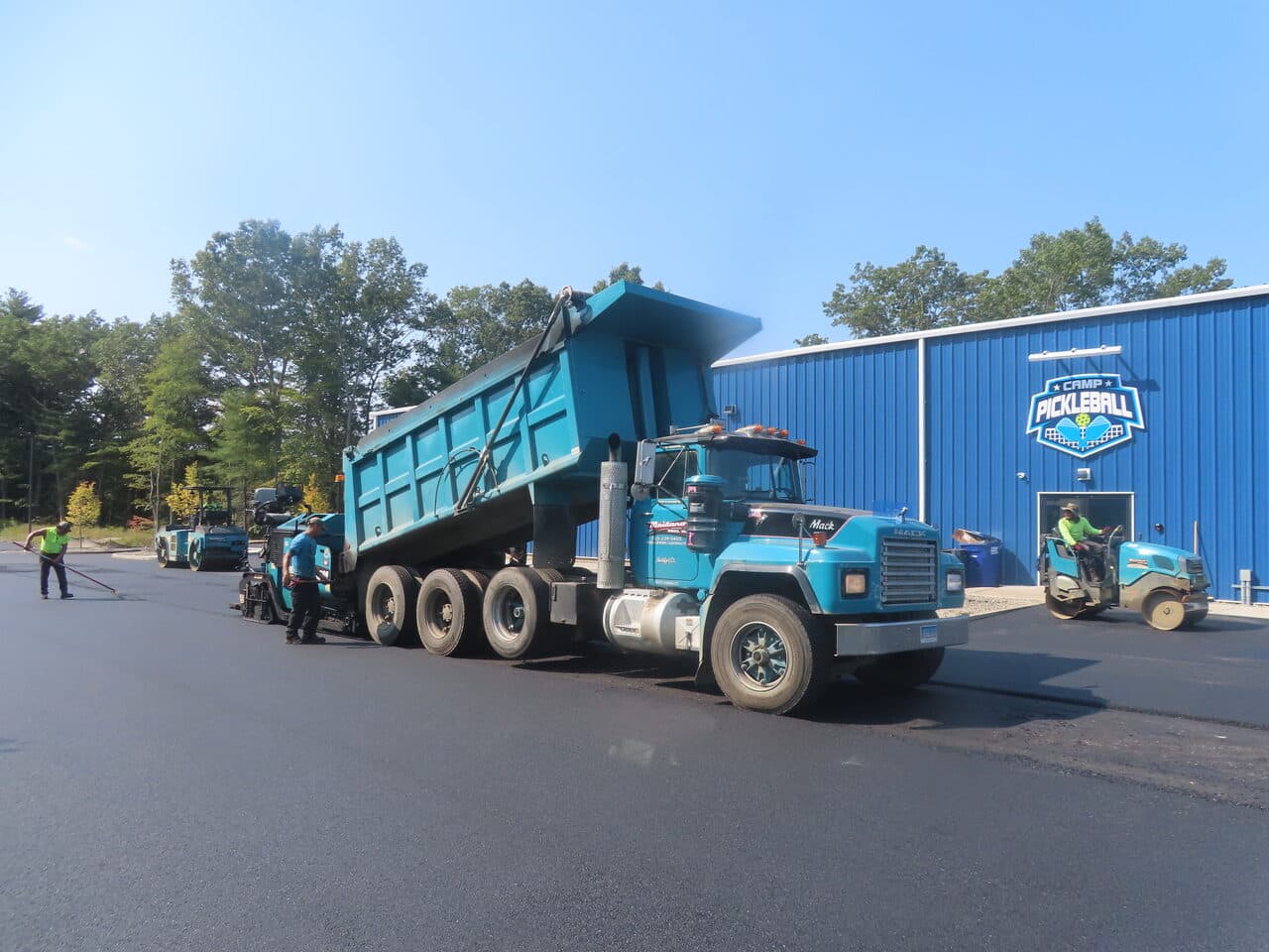 Commercial Parking Lot Paving project in Plainville, CT — dump truck paver at pickleball building
