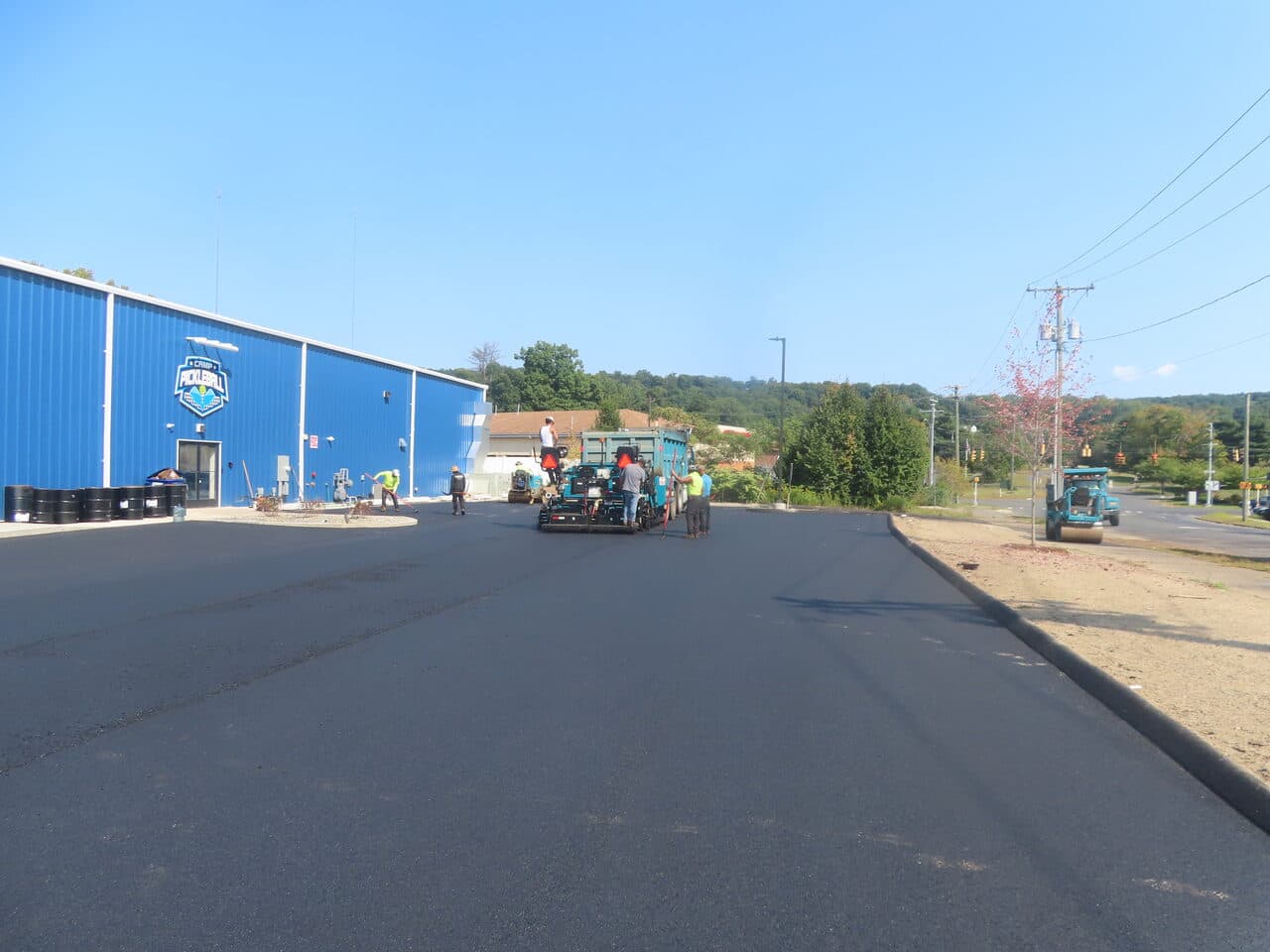 Commercial Parking Lot Paving project in Plainville, CT — crew paving near pickleball building