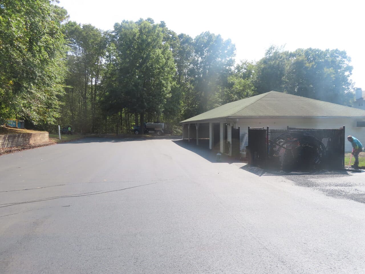 Commercial Parking Lot Paving project in Hamden, CT — finished fresh asphalt lot by carport