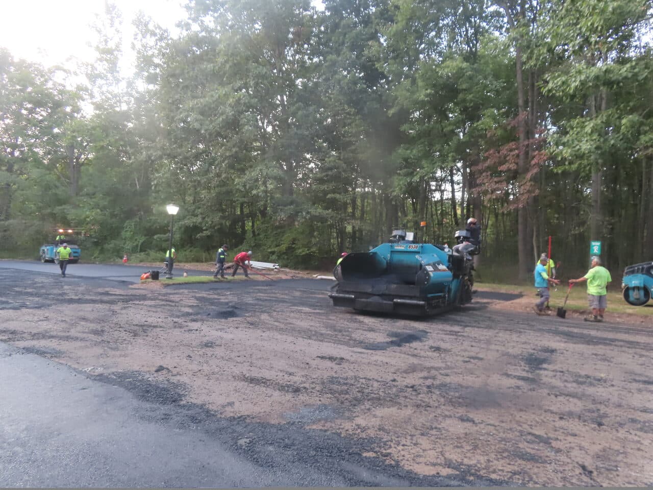 Commercial Parking Lot Paving project in Hamden, CT — paver and crew paving lot section
