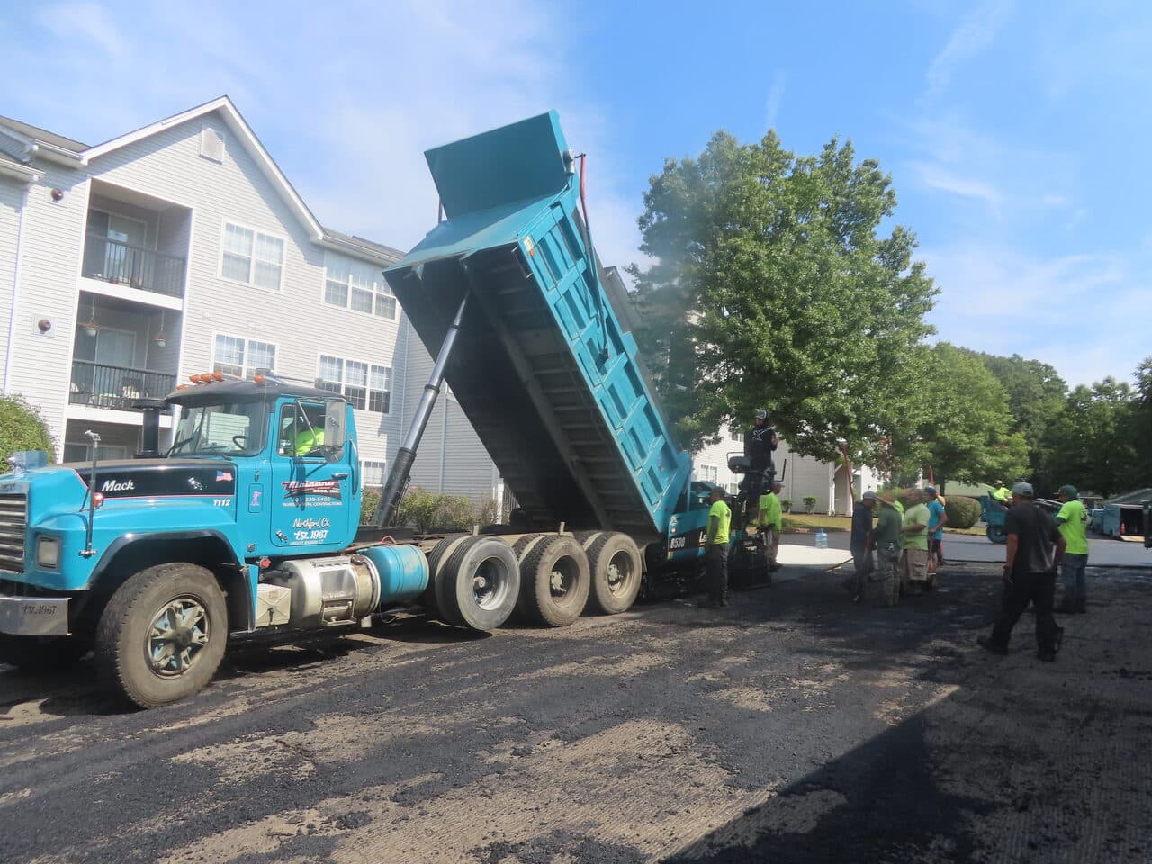 Commercial Parking Lot Paving project in Hamden, CT — dump truck unloading asphalt