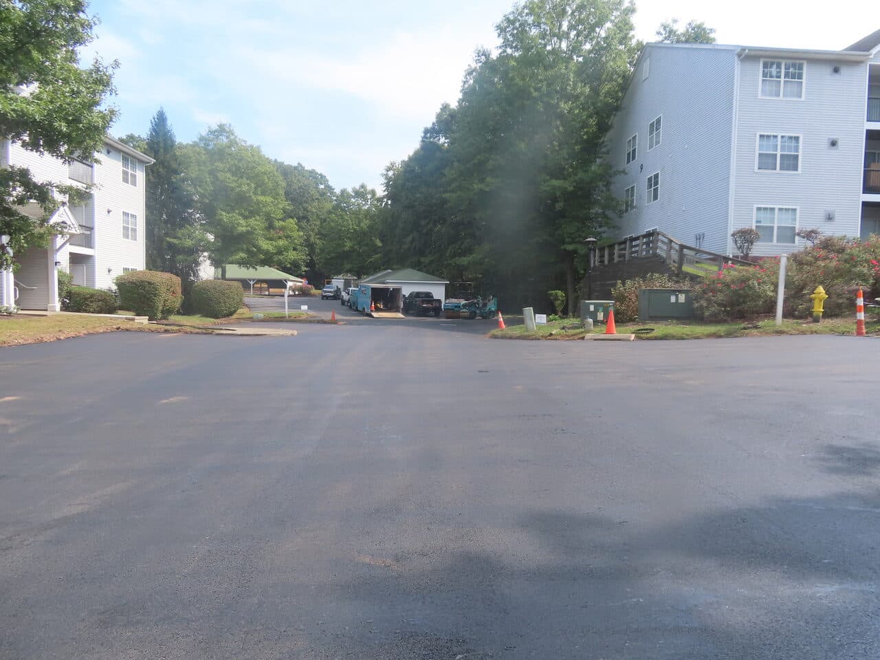 After — Commercial Parking Lot Paving in Hamden, CT (paver laying asphalt by carport)