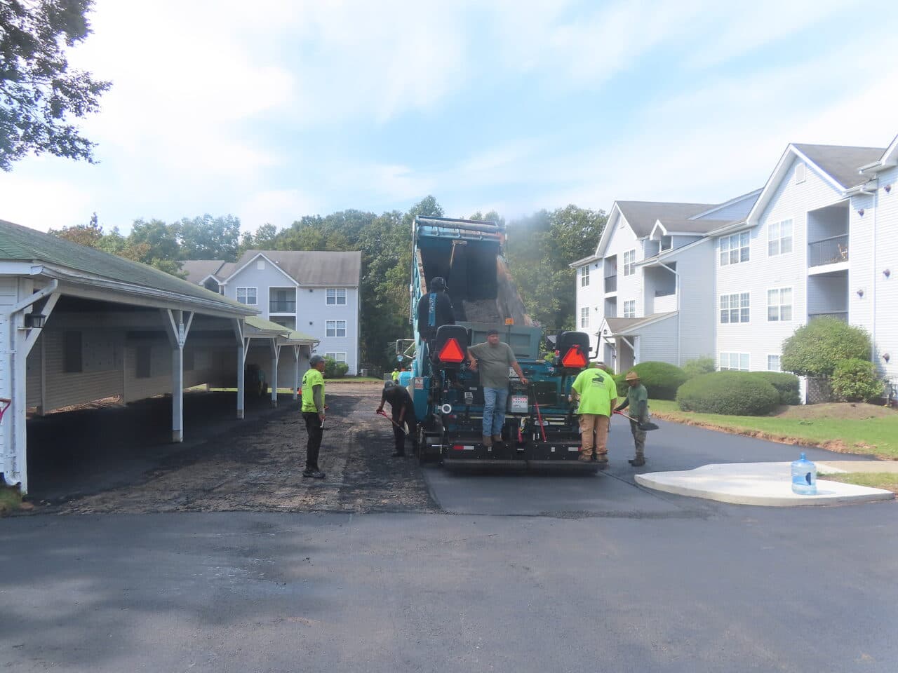 Commercial Parking Lot Paving project in Hamden, CT — paver and crew on new asphalt