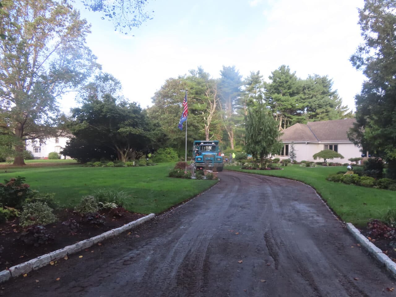 Residential Driveway Paving project in Branford, CT — paving truck on prepped driveway