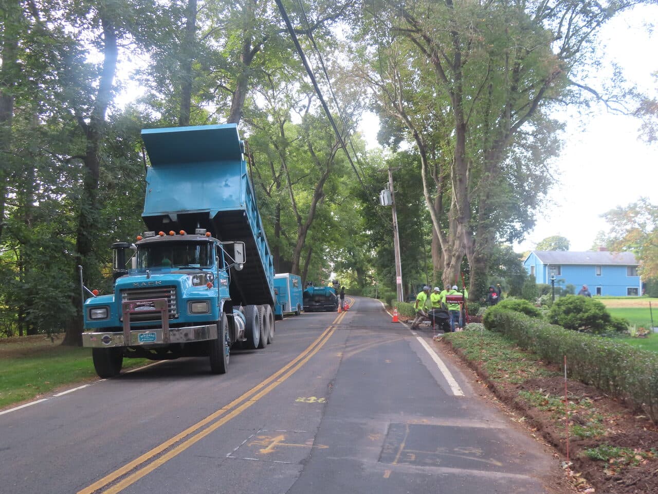 Residential Driveway Paving project in Branford, CT — dump trucks on road during job