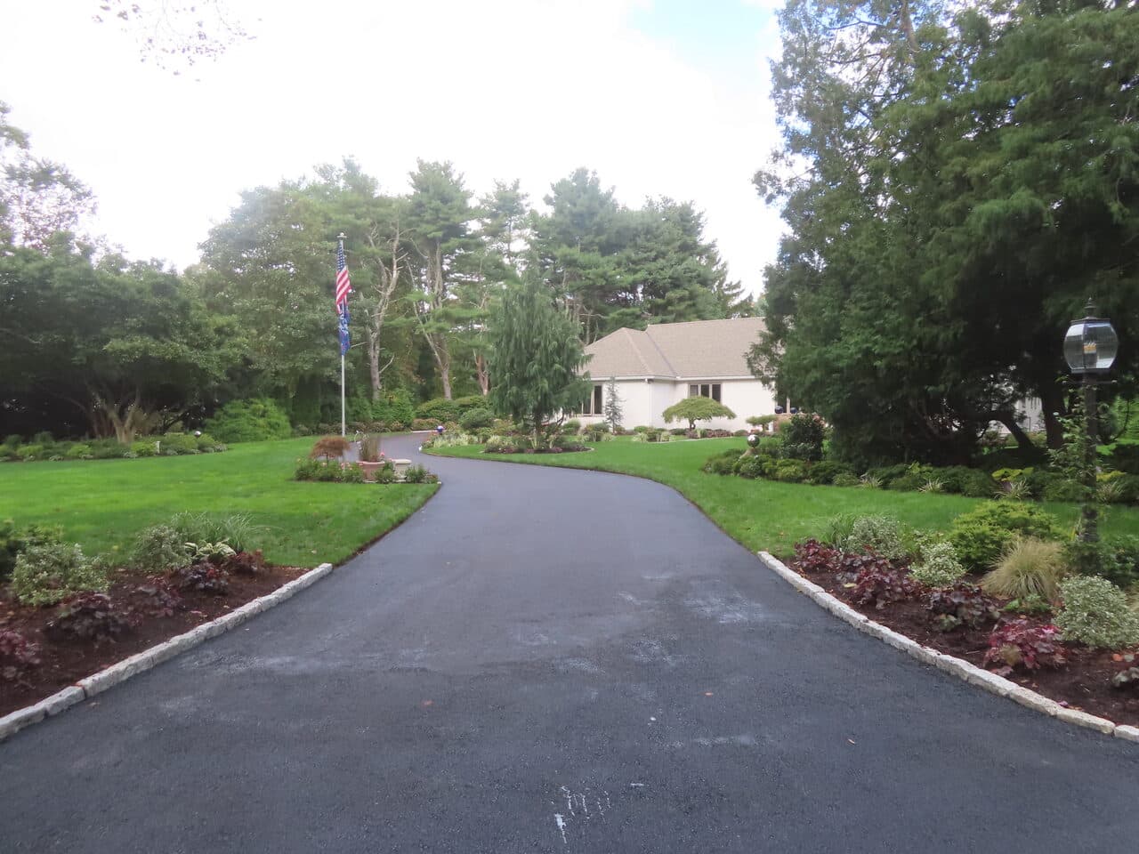 Residential Driveway Paving project in Branford, CT — finished asphalt driveway to home
