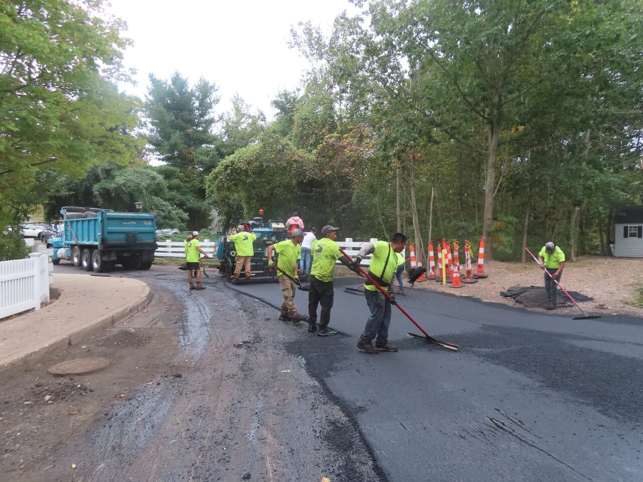 Commercial Parking Lot Paving project in Hamden, CT — crew raking asphalt at entrance