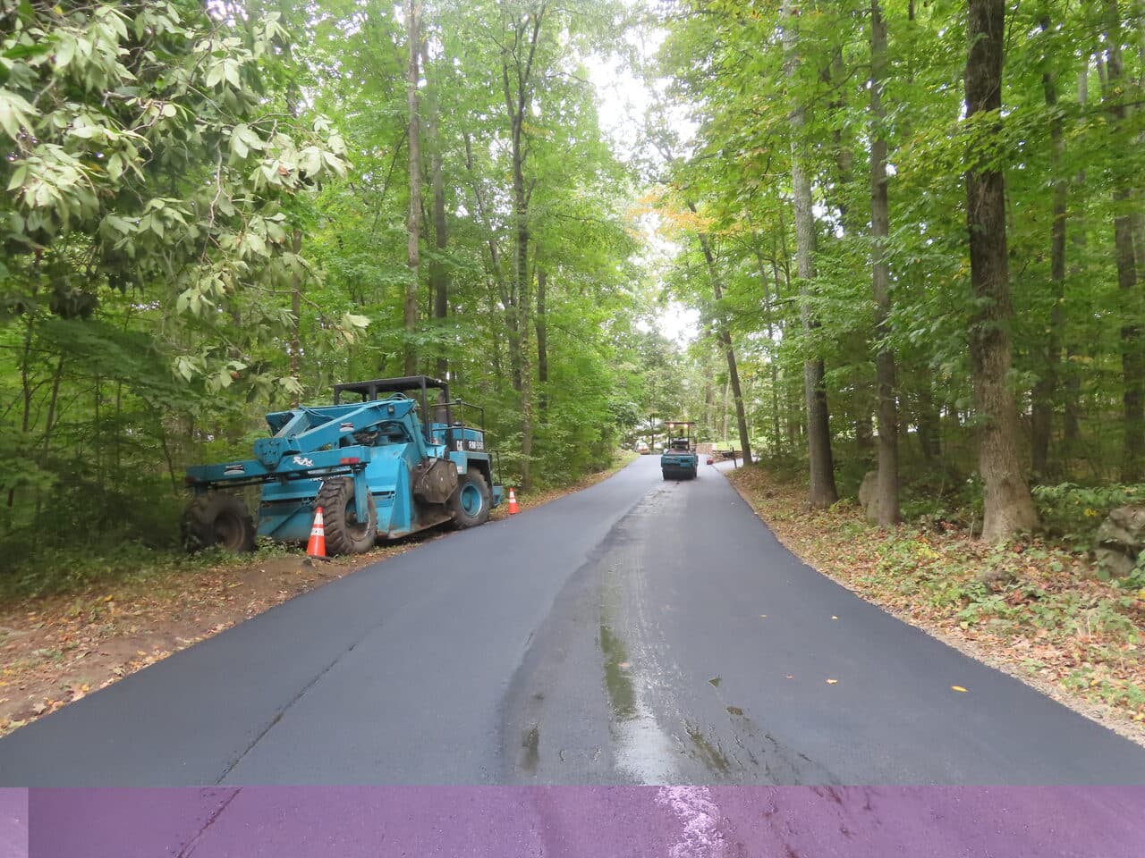 Roadway Paving project in Guilford, CT — paving with equipment along road