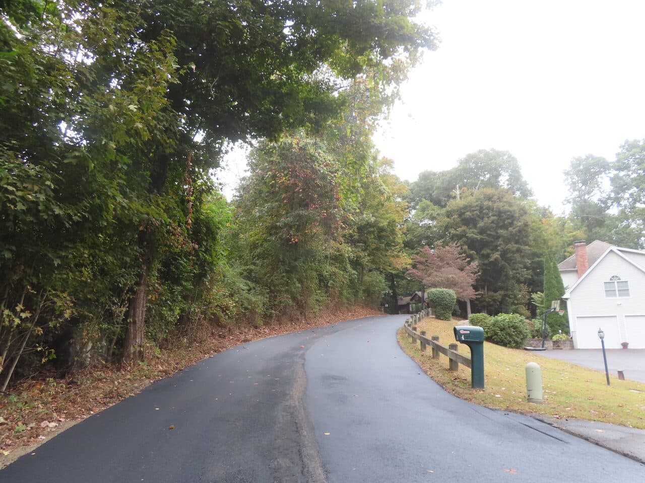 Roadway Paving project in Guilford, CT — finished asphalt road by house