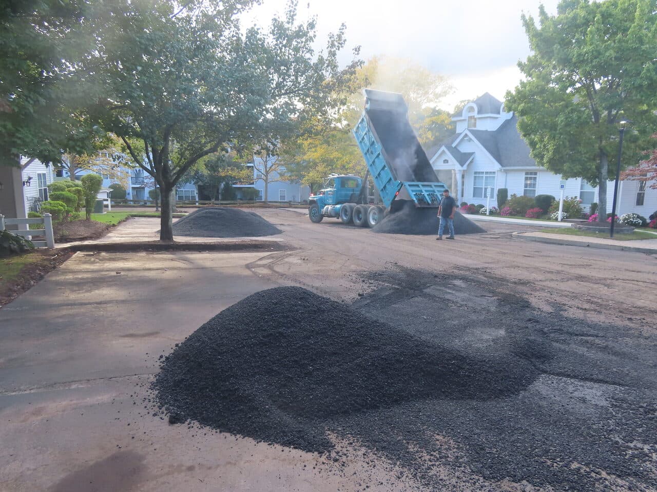 Commercial Parking Lot Paving project in Hamden, CT — dump truck dropping asphalt piles on lot