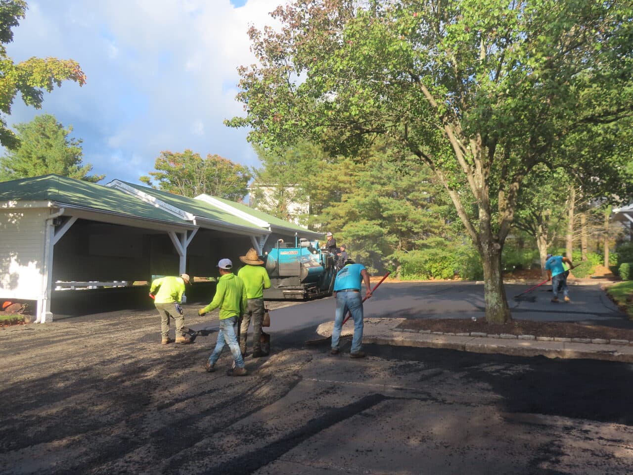 Commercial Parking Lot Paving project in Hamden, CT — crew and paver working near carport