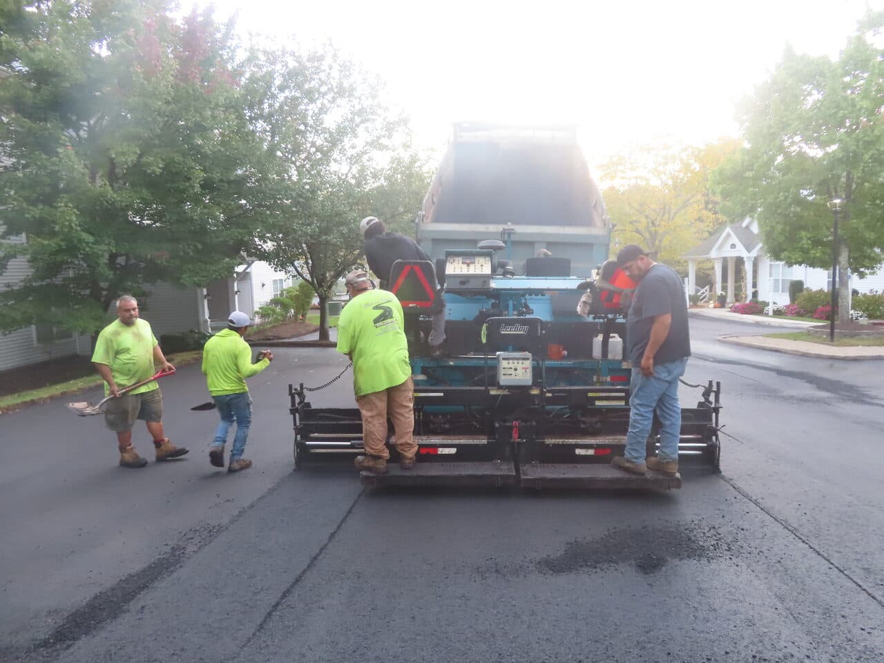 Commercial Parking Lot Paving project in Hamden, CT — crew behind paver on fresh asphalt