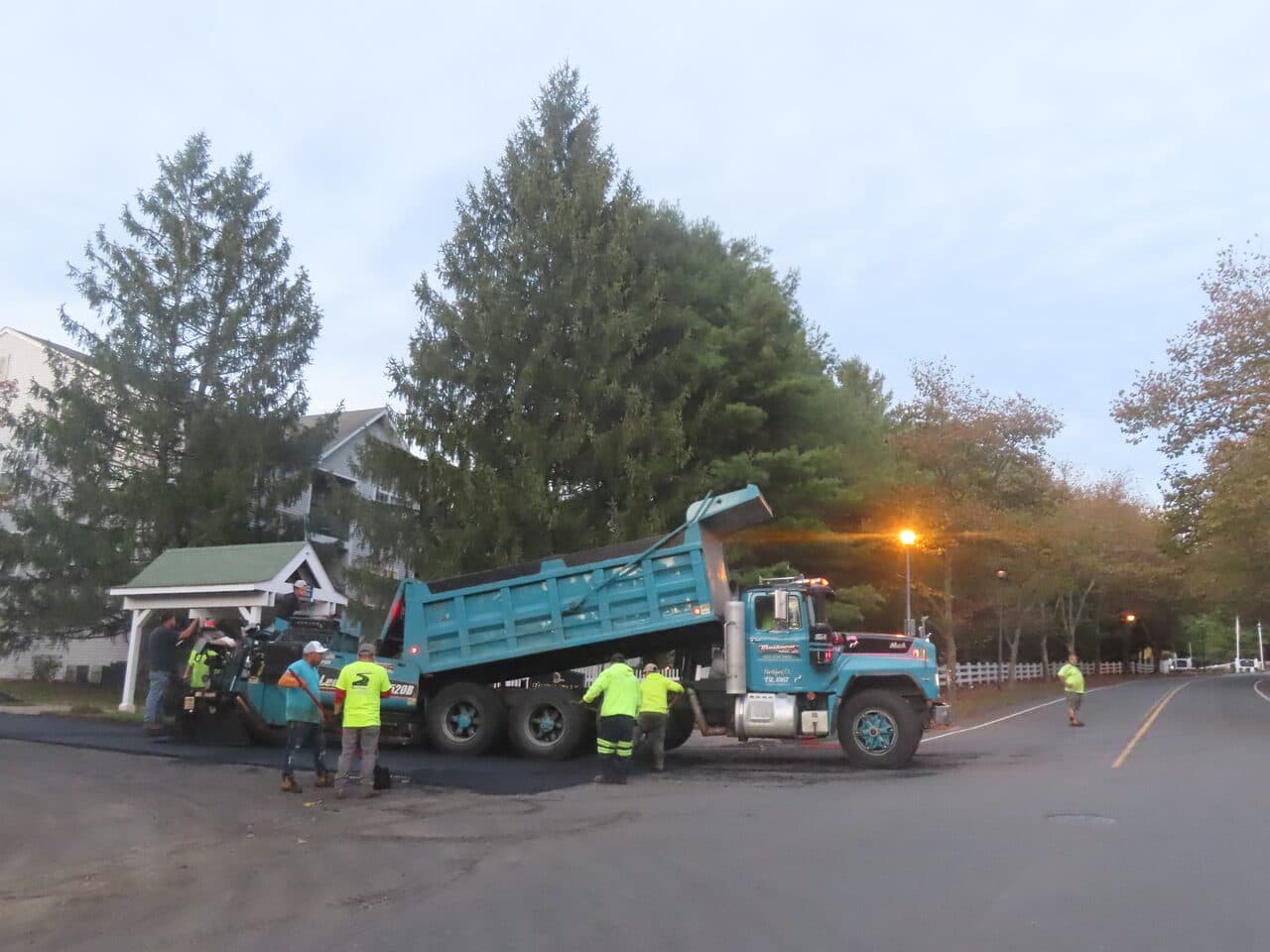 Commercial Parking Lot Paving project in Hamden, CT — paver and dump truck paving entrance road