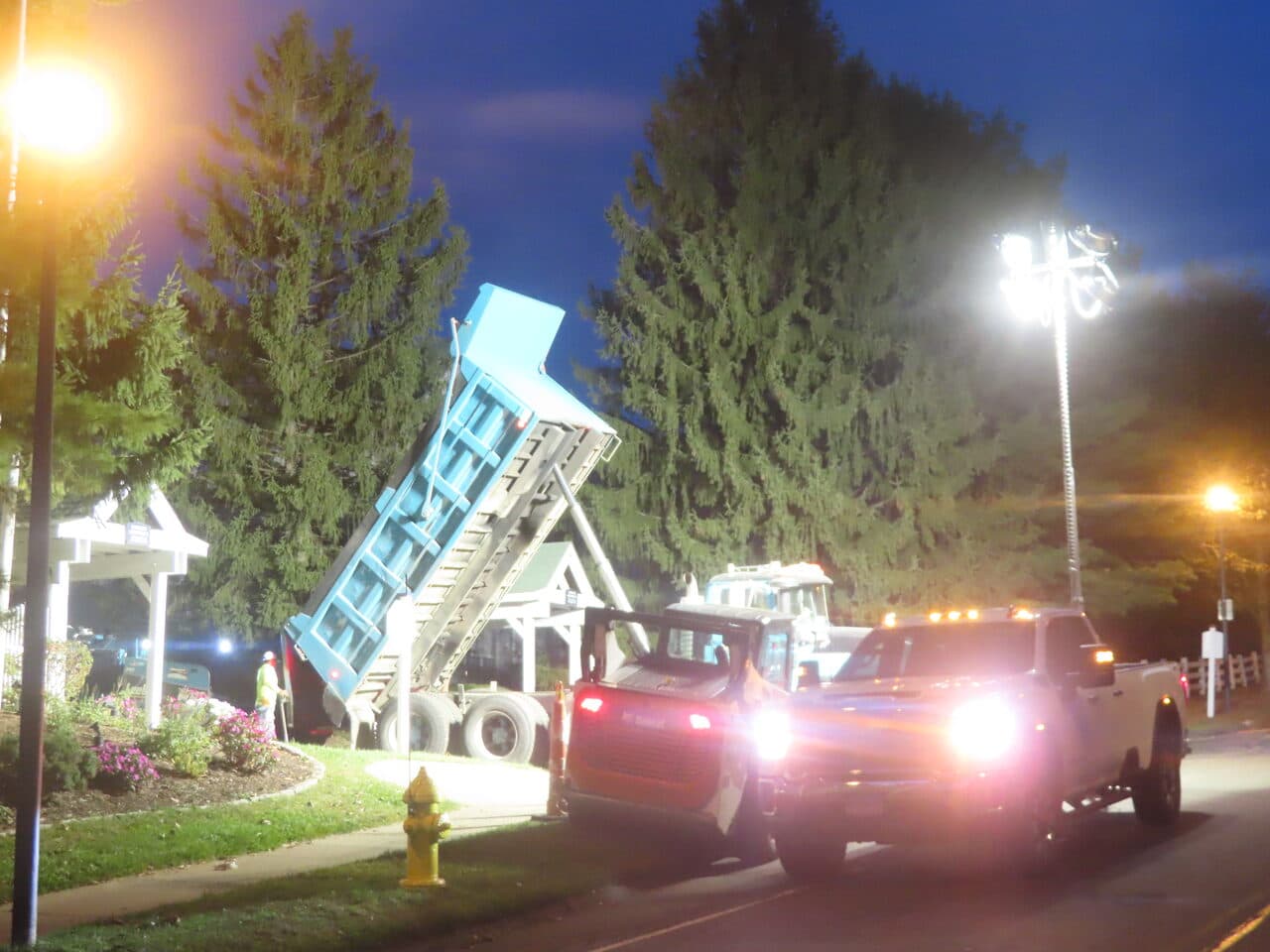 Commercial Parking Lot Paving project in Hamden, CT — dump truck raising bed at night