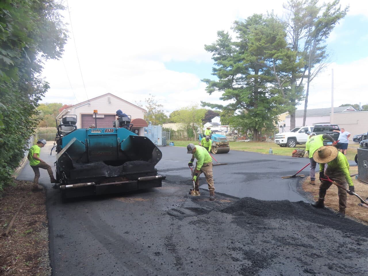 Commercial Parking Lot Paving project in East Haven, CT — paving crew laying asphalt with paver