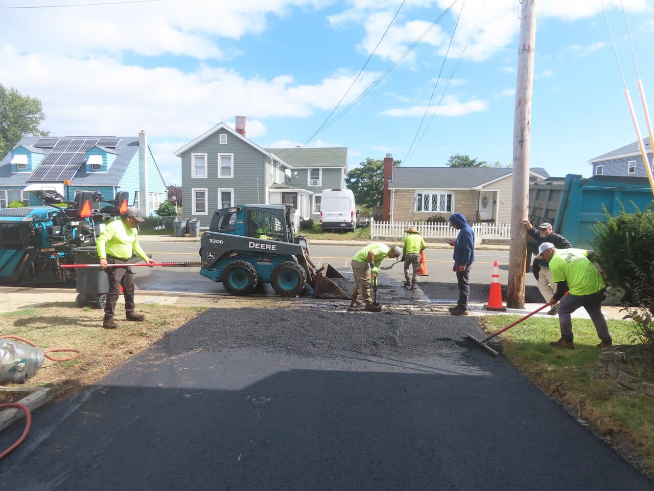 Commercial Parking Lot Paving project in East Haven, CT — crew raking asphalt apron at street