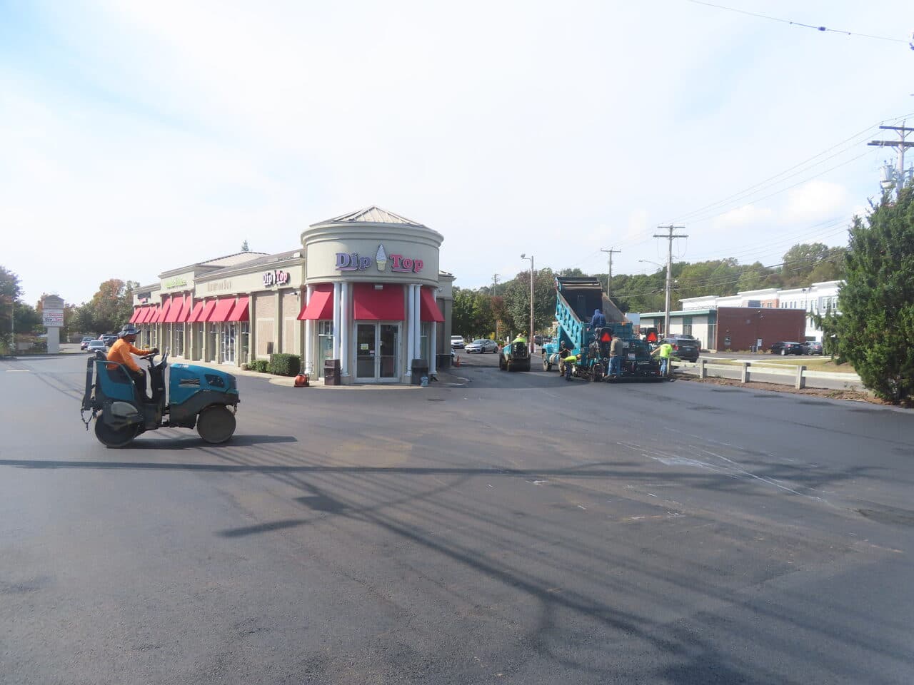 Commercial Parking Lot Paving project in Orange, CT — roller on fresh lot by Dip Top
