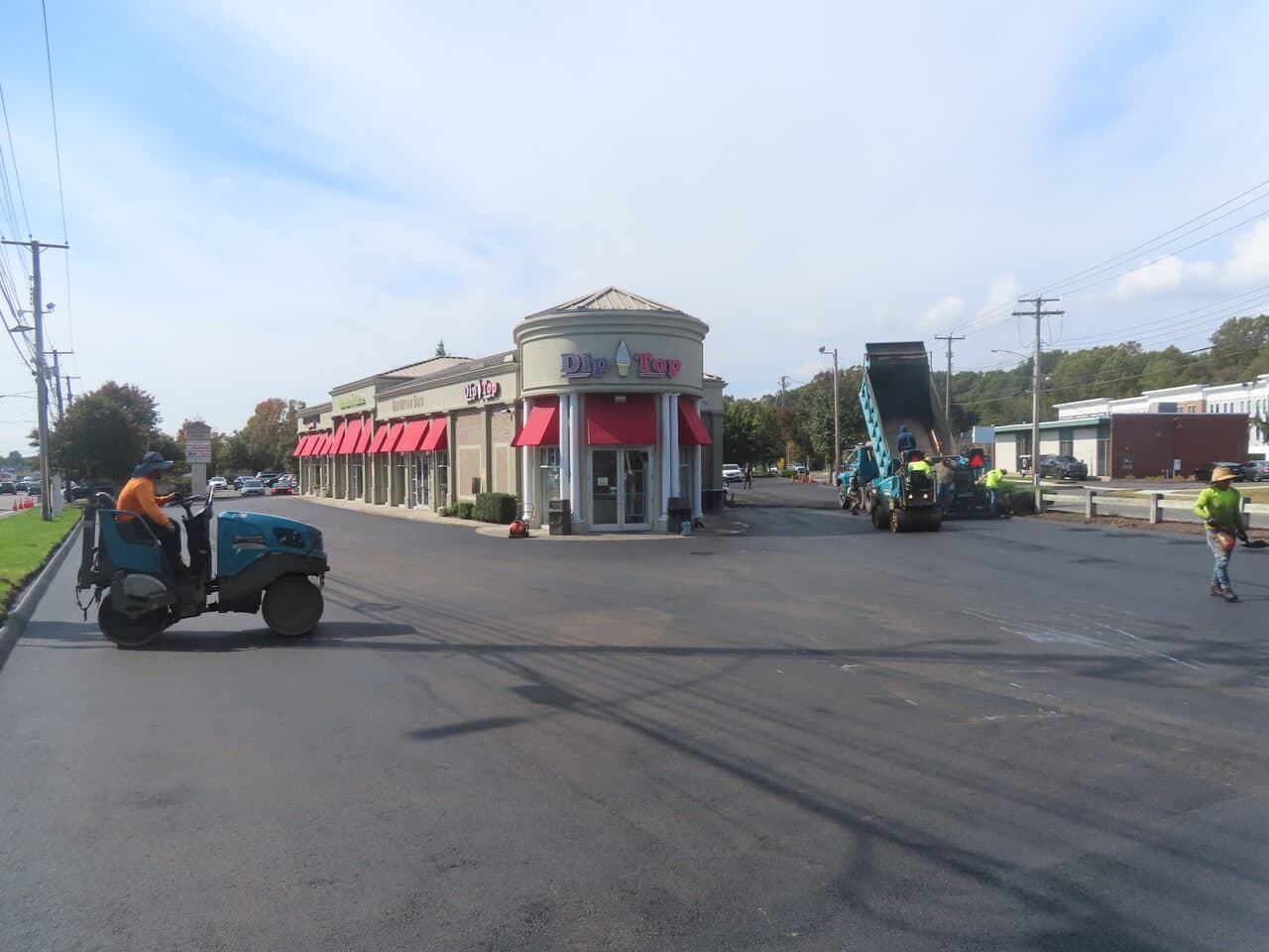 Commercial Parking Lot Paving project in Orange, CT — roller on new asphalt commercial plaza