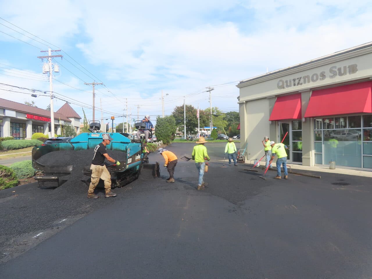 Commercial Parking Lot Paving project in Orange, CT — paving crew at Quiznos plaza lot