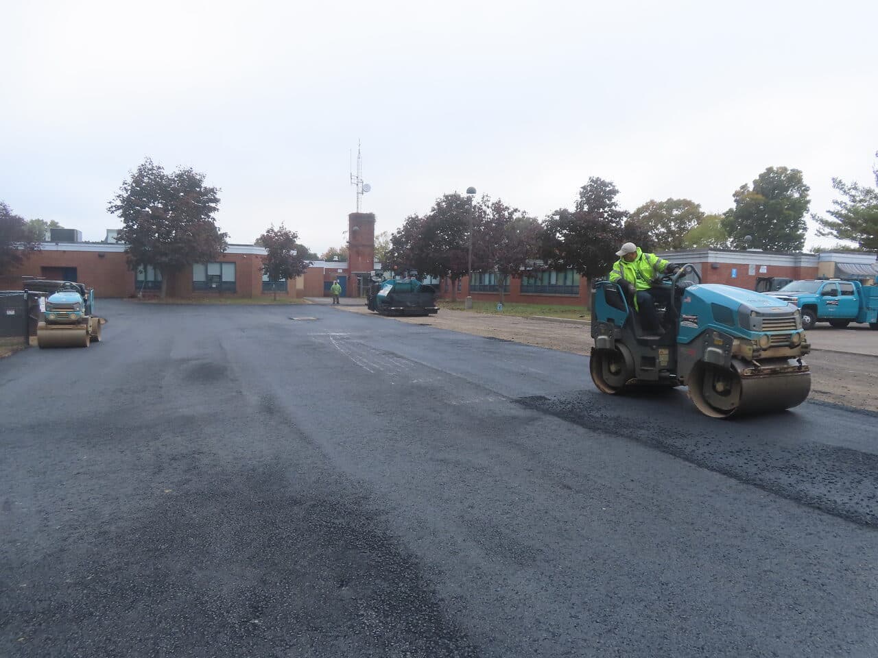 Commercial Parking Lot Paving project in West Haven, CT — fresh asphalt rolling at school