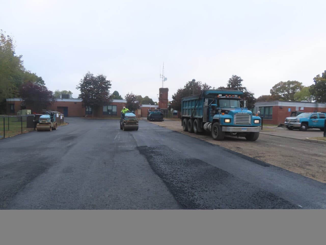 Commercial Parking Lot Paving project in West Haven, CT — paving lot with dump truck and rollers