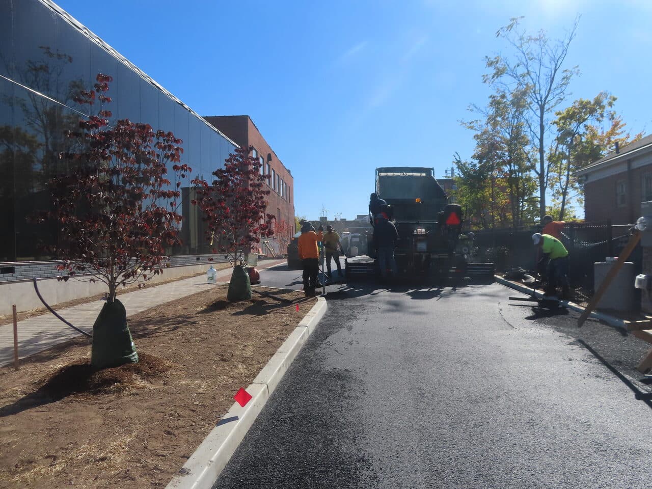 Commercial Parking Lot Paving project in Hartford, CT — dump truck and roller paving drive