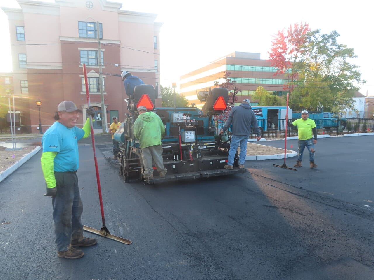 Commercial Parking Lot Paving project in Hartford, CT — crew paving lot at dusk
