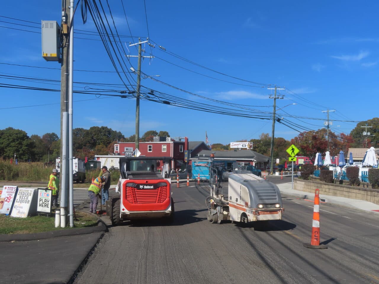 Roadway Paving project in Branford, CT — Bobcat and milling machine on road