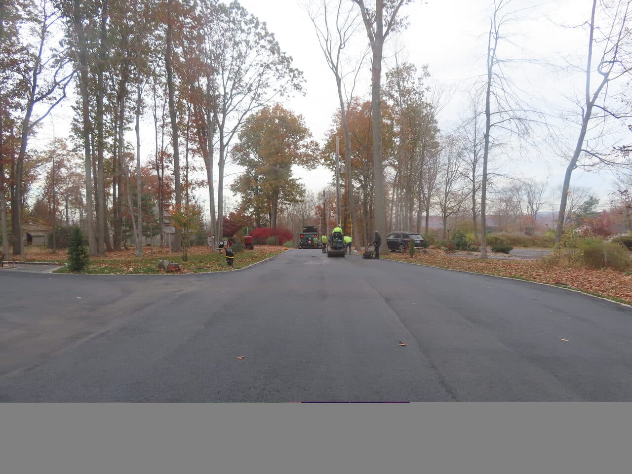 Residential Driveway Paving project in North Haven, CT — paving crew working down road