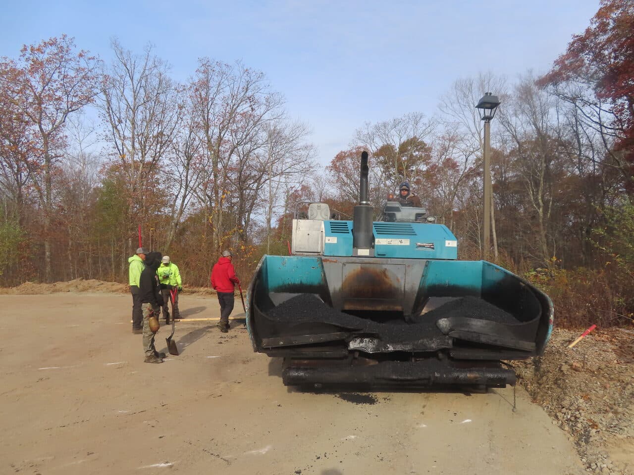 Roadway Paving project in Higganum, CT — paver and crew on lot