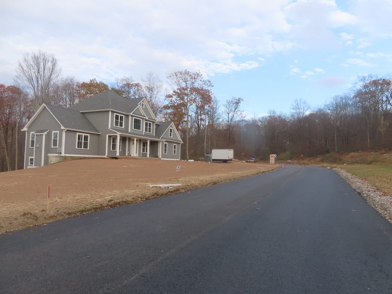 Roadway Paving project in Higganum, CT — finished road past new home