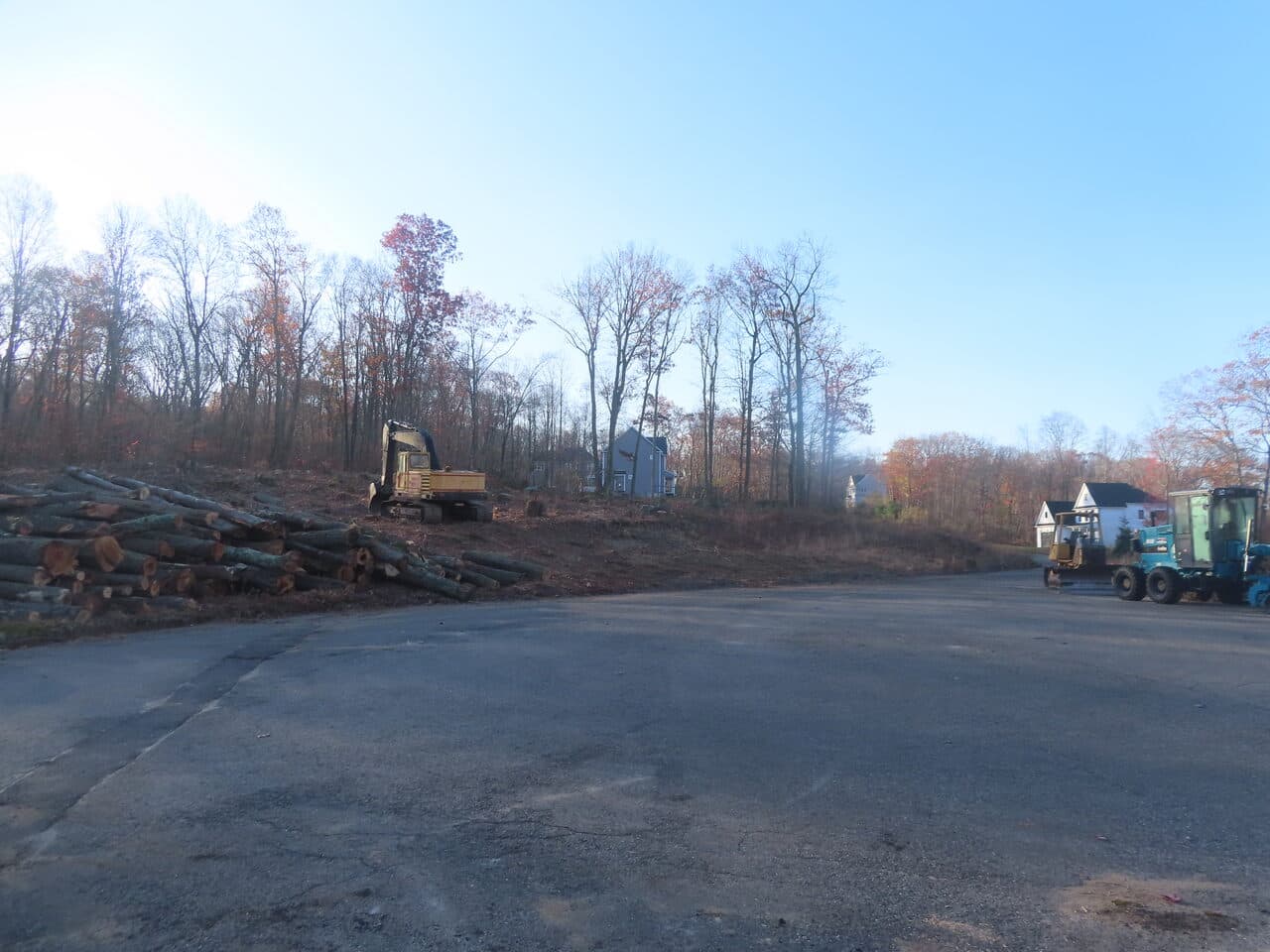 Roadway Paving project in Higganum, CT — paved lot with log piles and machinery
