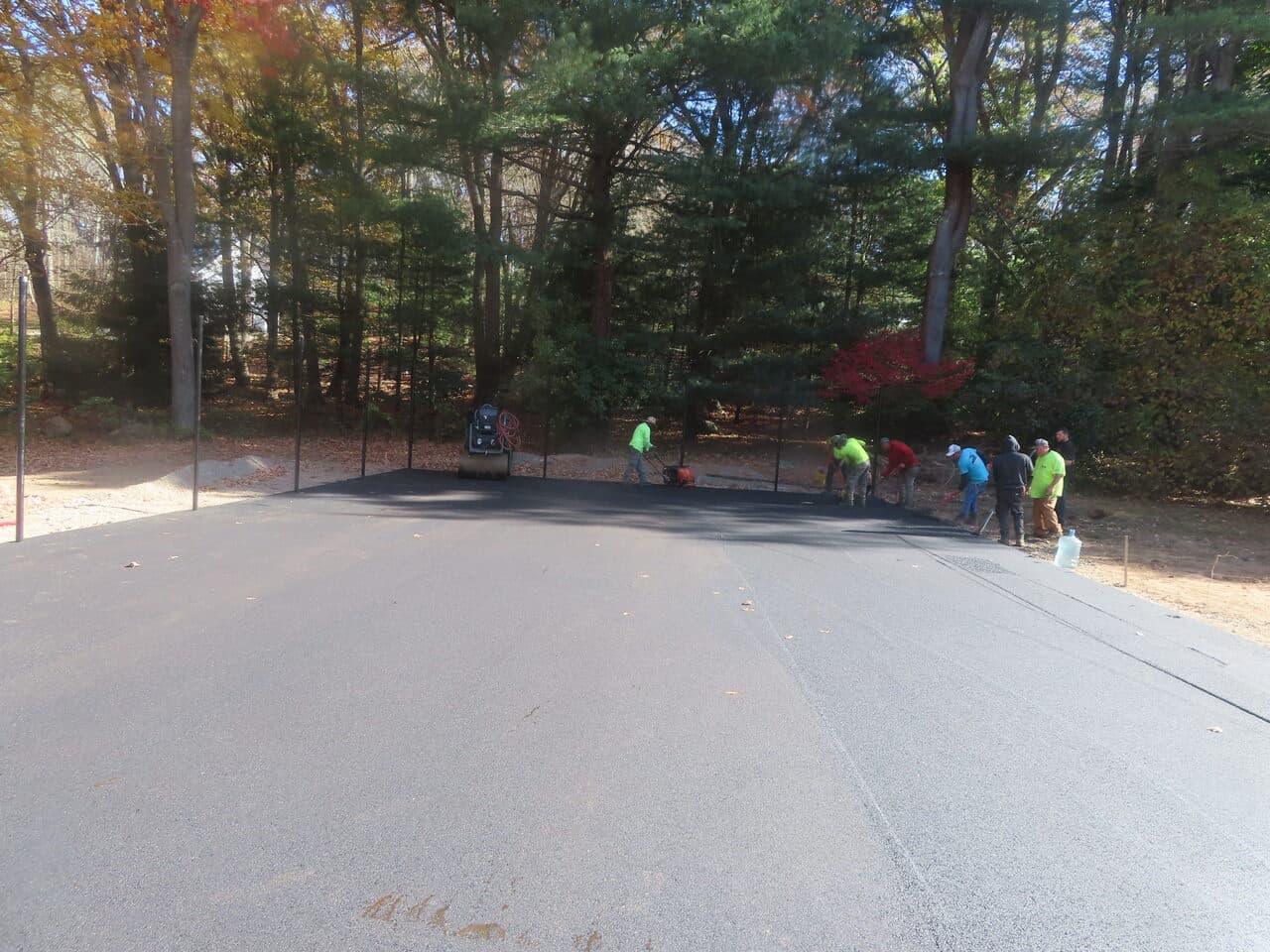Residential Driveway Paving project in Stonington, CT — crew finishing fresh asphalt apron