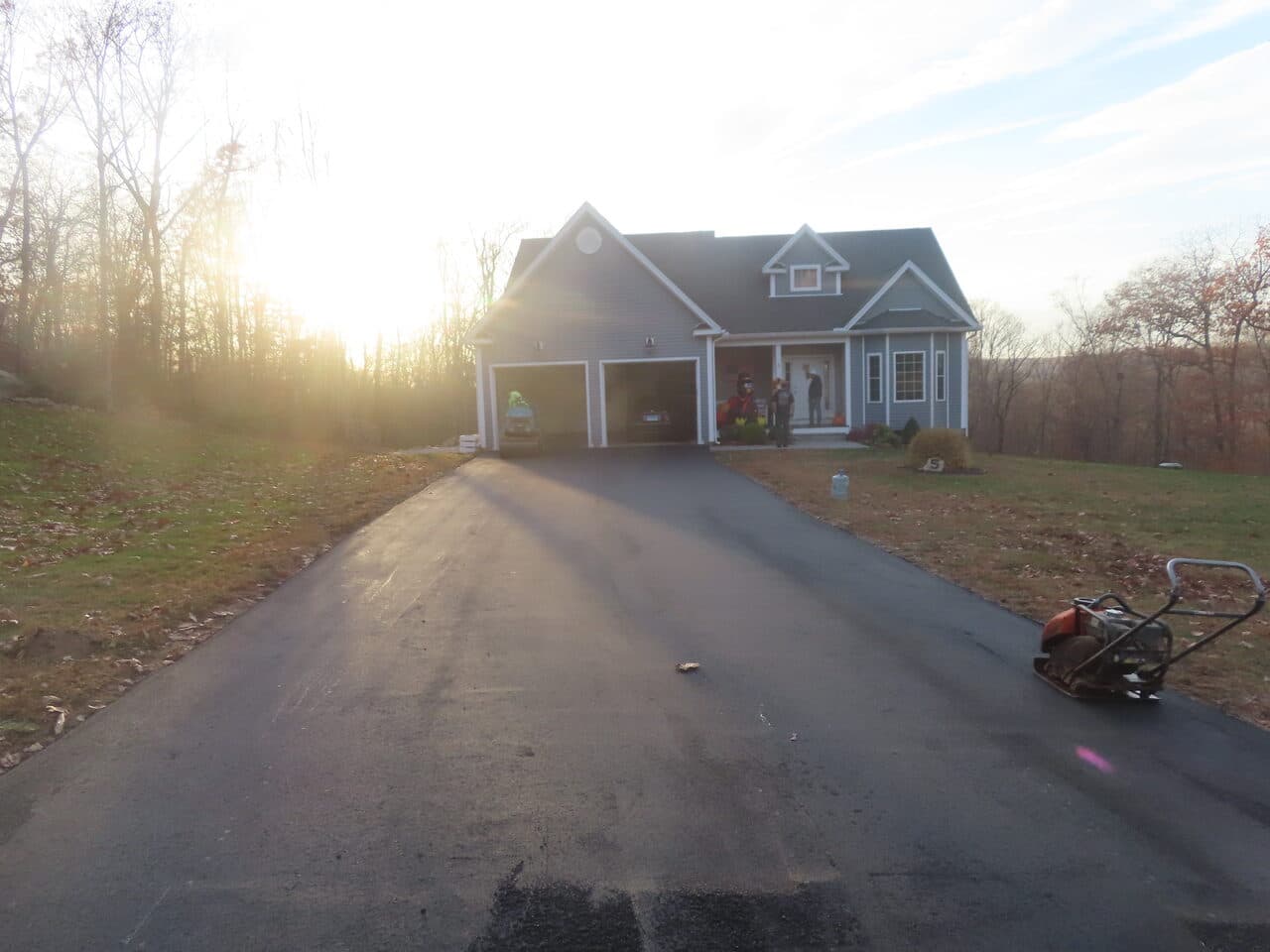 Residential Driveway Paving project in Stonington, CT — finished driveway to garage at sunset