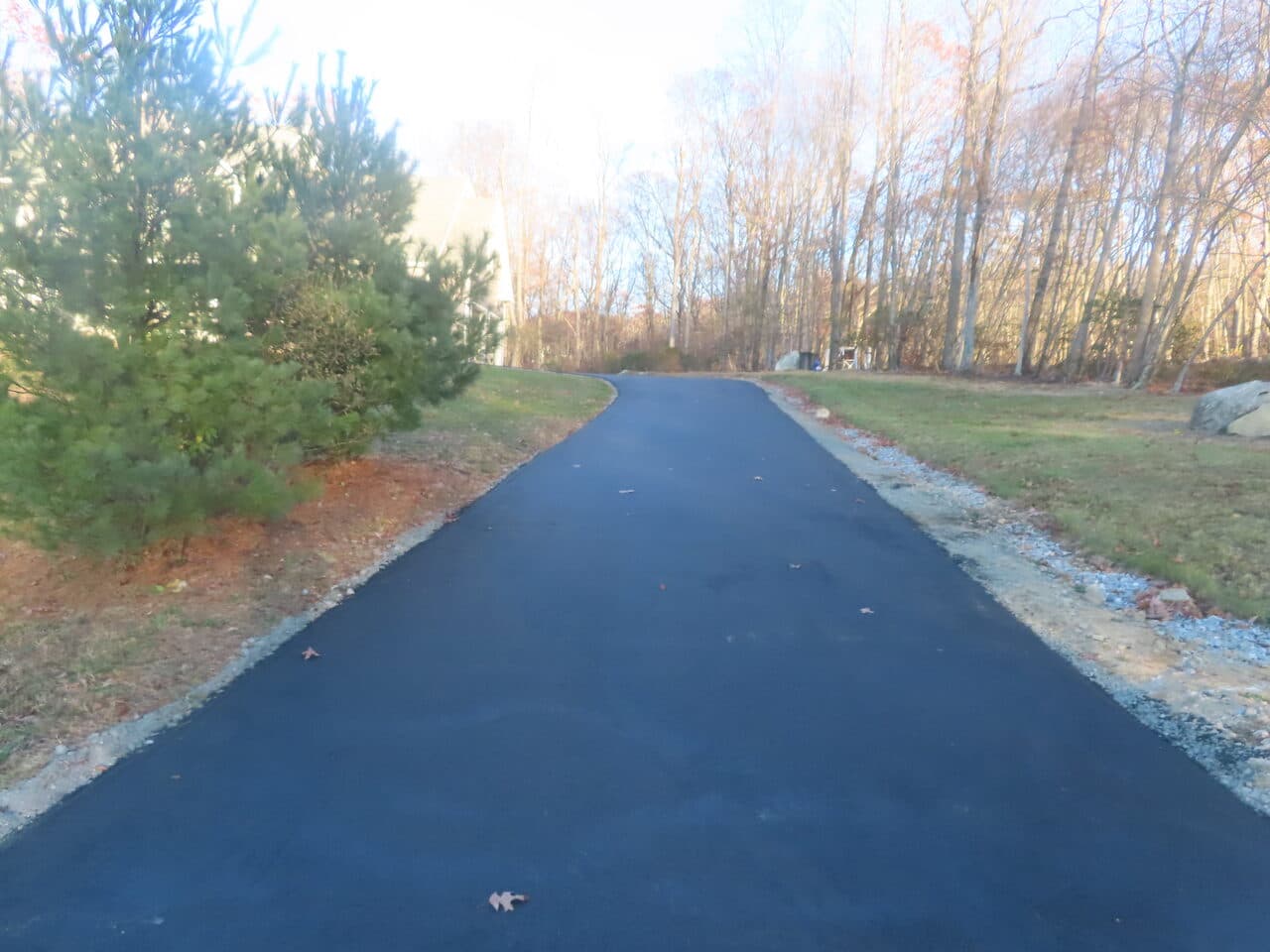 Residential Driveway Paving project in Middletown, CT — finished black asphalt driveway tree-lined