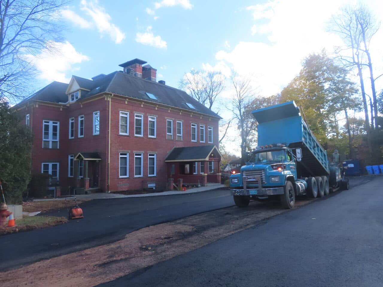 Commercial Parking Lot Paving project in Meriden, CT — dump truck paving by brick building