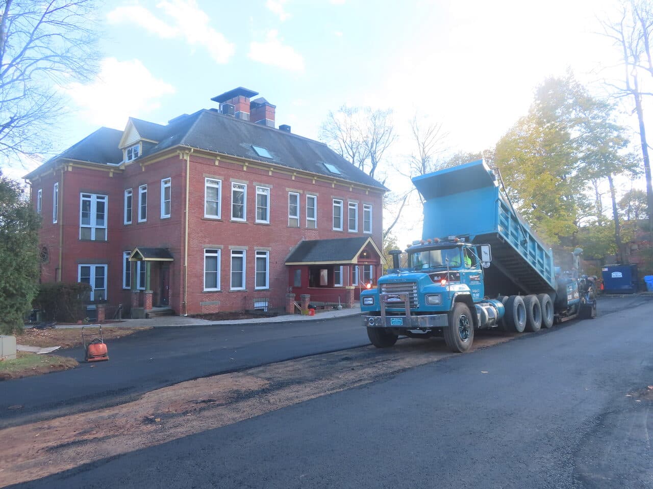 Commercial Parking Lot Paving project in Meriden, CT — dump truck paving by brick building