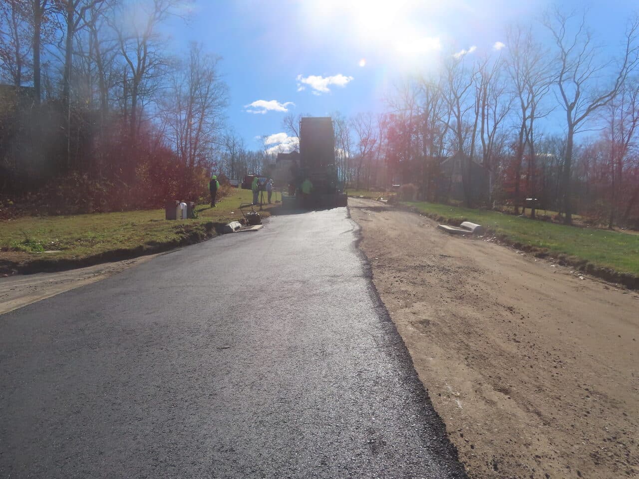 Roadway Paving project in Higganum, CT — fresh paved road with paver