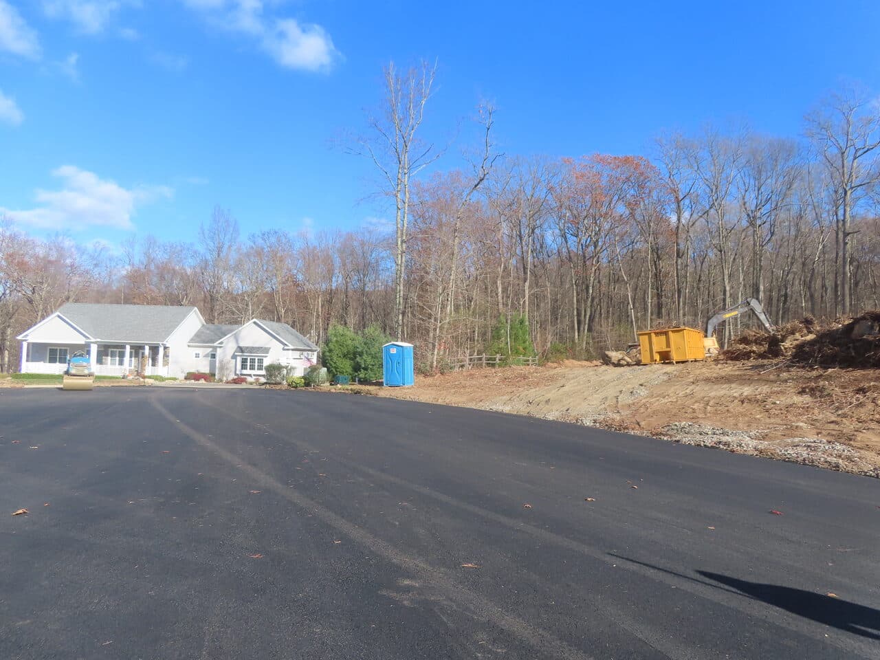 Roadway Paving project in Higganum, CT — finished asphalt lot with dumpster