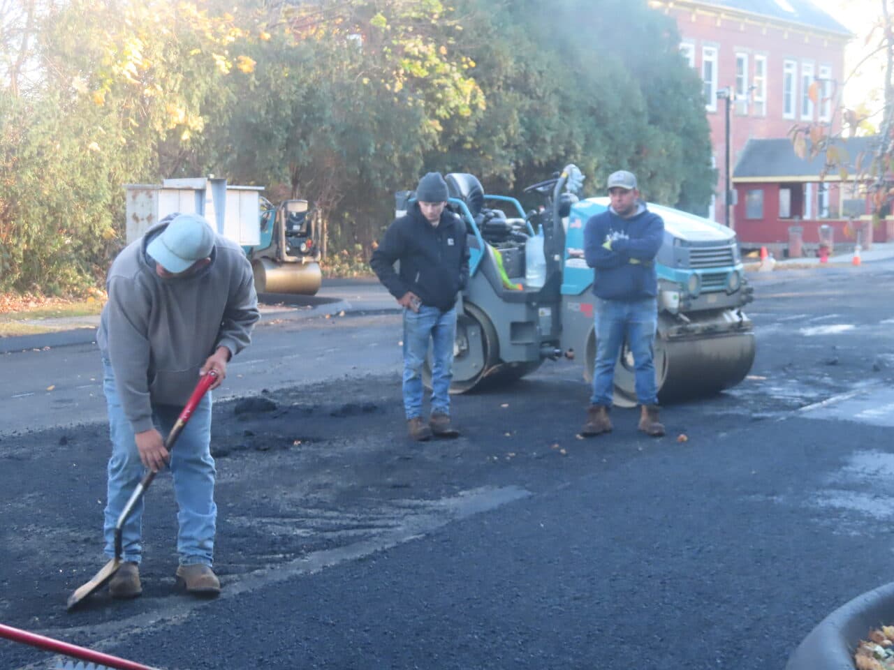 Commercial Parking Lot Paving project in Meriden, CT — crew with roller finishing lot