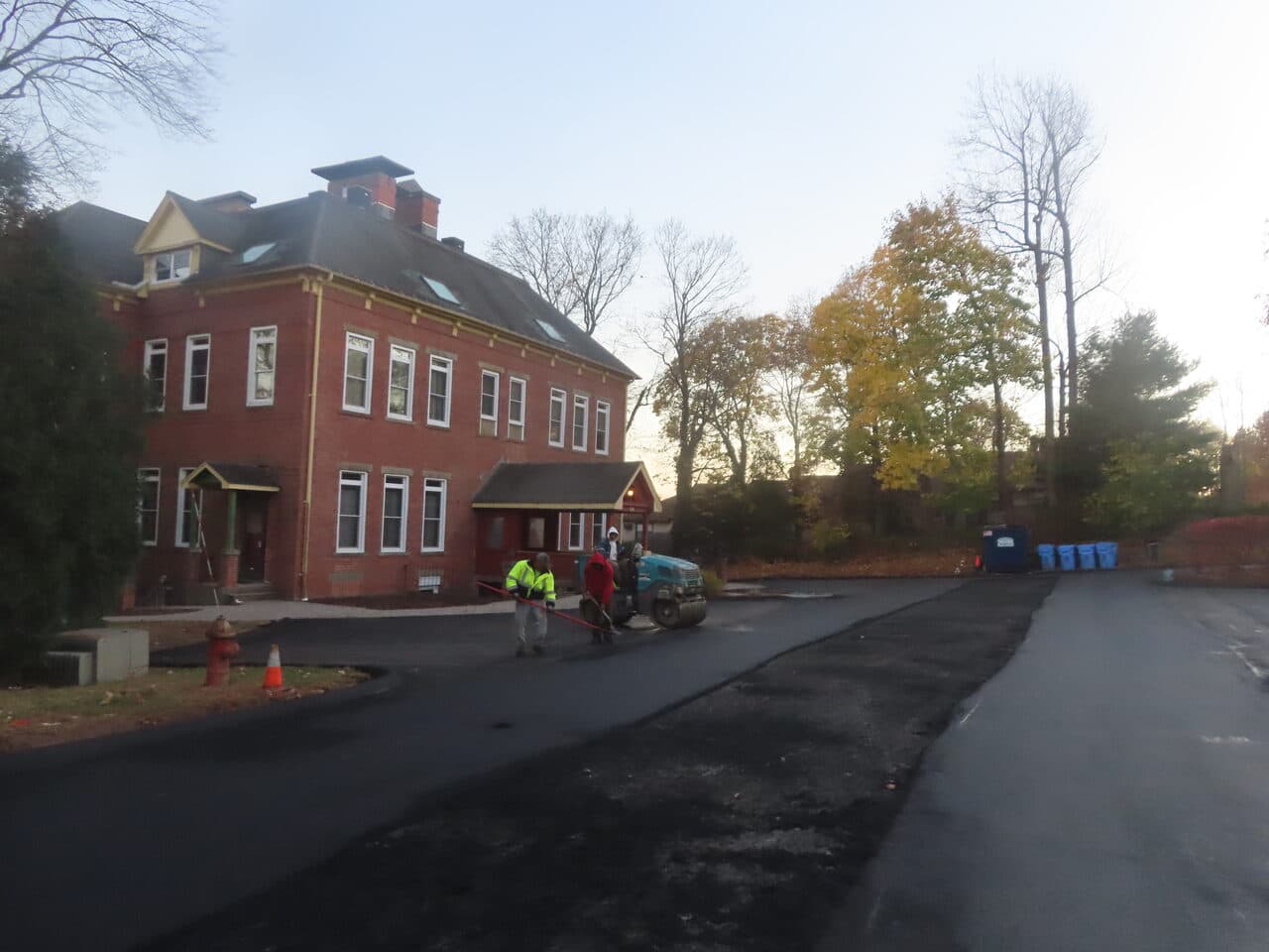 Commercial Parking Lot Paving project in Meriden, CT — roller compacting lot by brick building