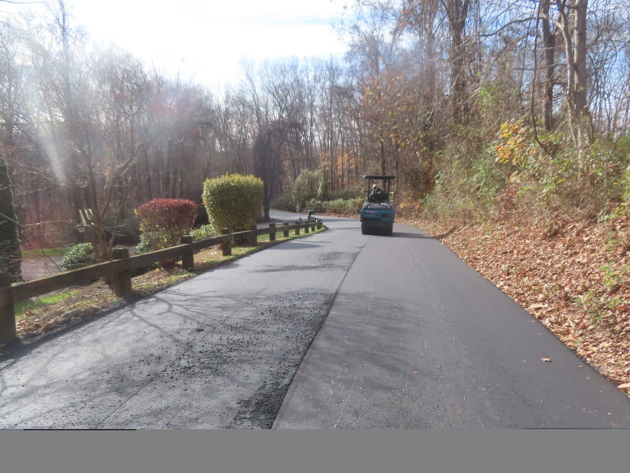 Roadway Paving project in Guilford, CT — fresh asphalt lane with roller