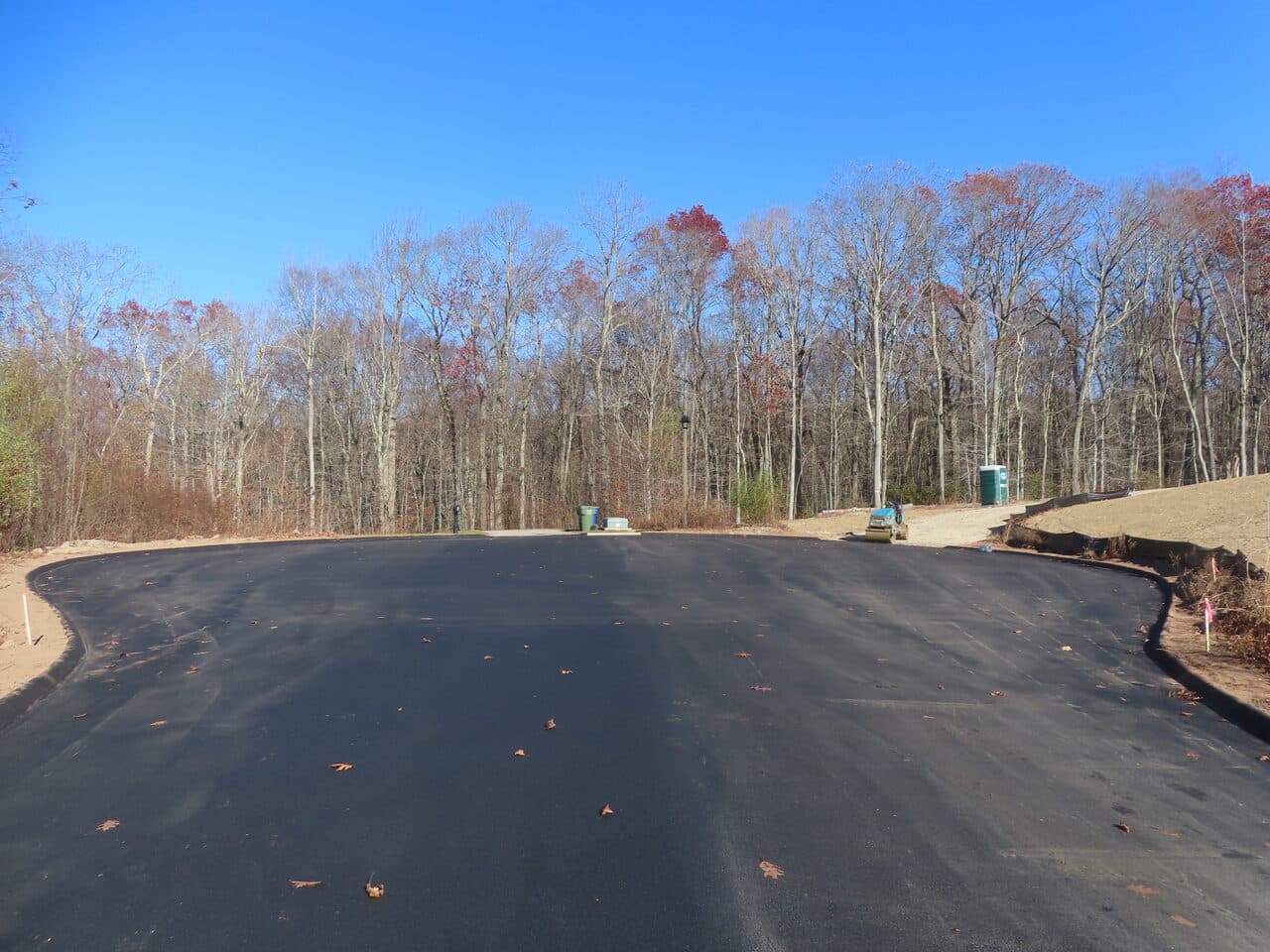Roadway Paving project in Higganum, CT — fresh asphalt cul-de-sac in woods
