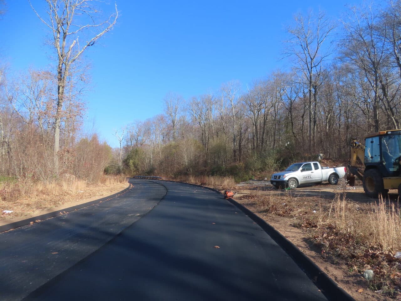 Roadway Paving project in Higganum, CT — fresh paved road with work truck