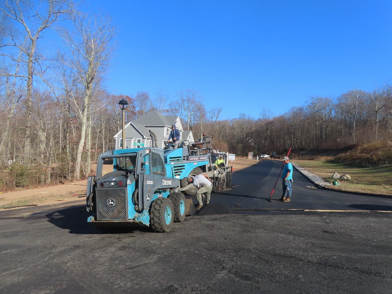 Roadway Paving project in Higganum, CT — skid steer and paver on new road